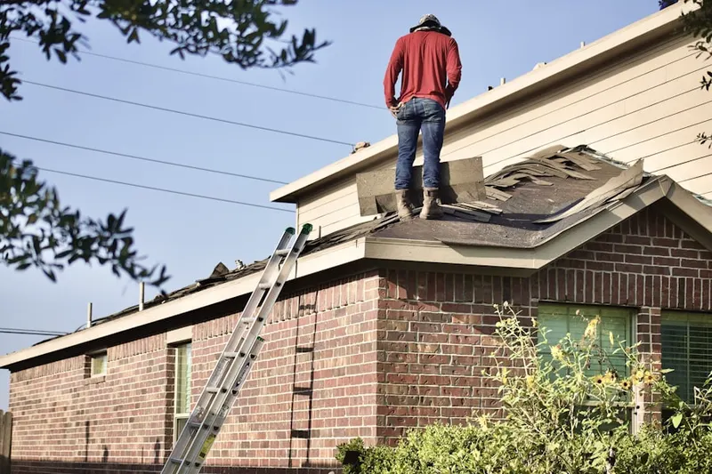 Professional roofer working on a residential roof in Little Plains